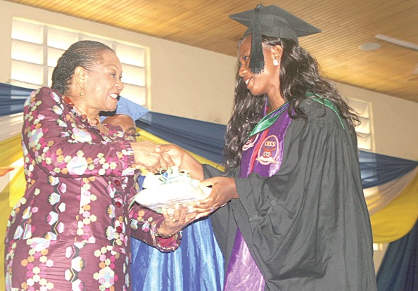 Ms Joyce Aryee (left), Executive Director of the Salt and Light Ministries, presenting the overall best female student award to Diana Antwi during the graduation ceremony of the Institute of Technology in Accra.