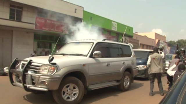 Video footage appears to show a canister being thrown into the mayor's vehicle, which then fills with smoke