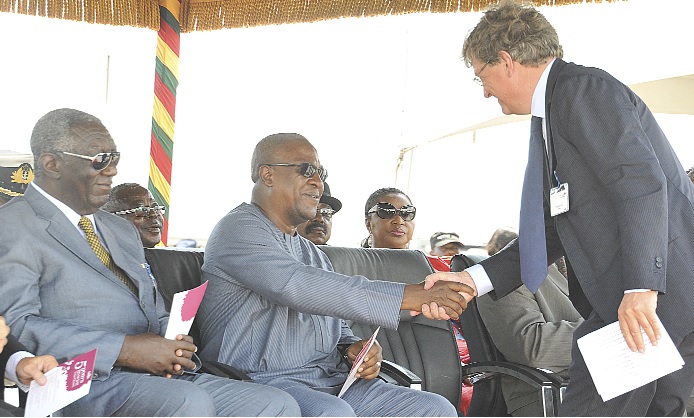President Mahama congratulating Mr Jos de Loor, Cargill Business Unit Leader. With them is former President J.A Kufuor. 