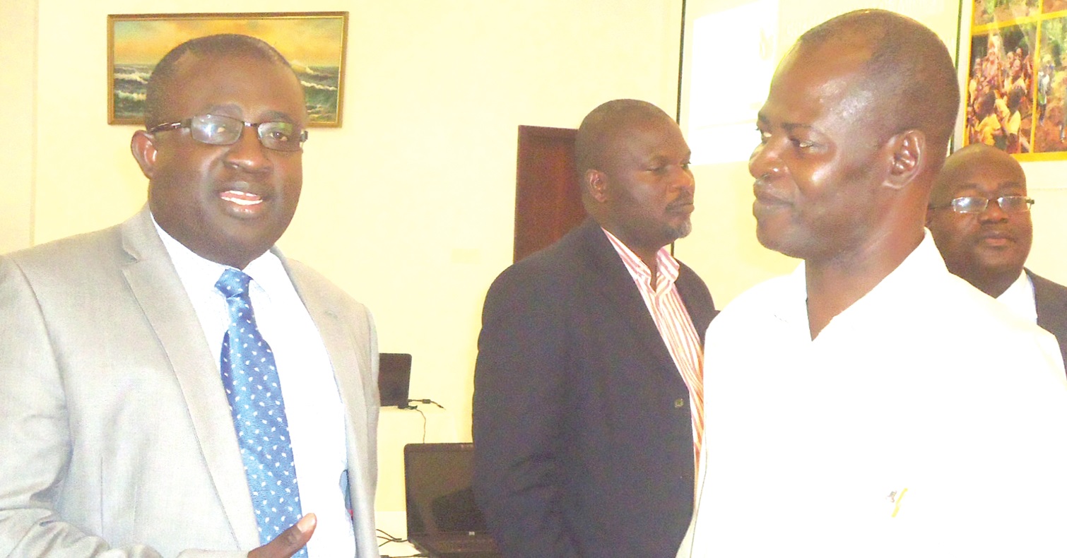Dr Toni Aubynn (left) interacting with Dr Steve Manteaw at the end of the Mining for Development Forum.