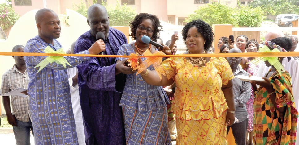 Ms Esther Happy Edjeami (right), acting head of Pre-Tertiary Private School, GES, Mrs Emenefa Acheampong (2nd right), head of Rising Sun Montessori School, Bortianor and Kenneth Thompson (2nd left), join hands to cut the tape to commission the new school building.                  