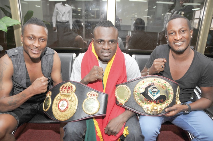 Tagoe (middle) displaying some of his belts. He is flanked by the Gyan brothers, Baffour (left) and Nana Kwame.
