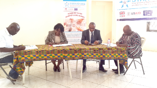 The Programme Manager of STAR-Ghana, Mr Ibrahin-Tanko Amidu (seated right) signing the grant contract agreement with the representatives of other media houses.  