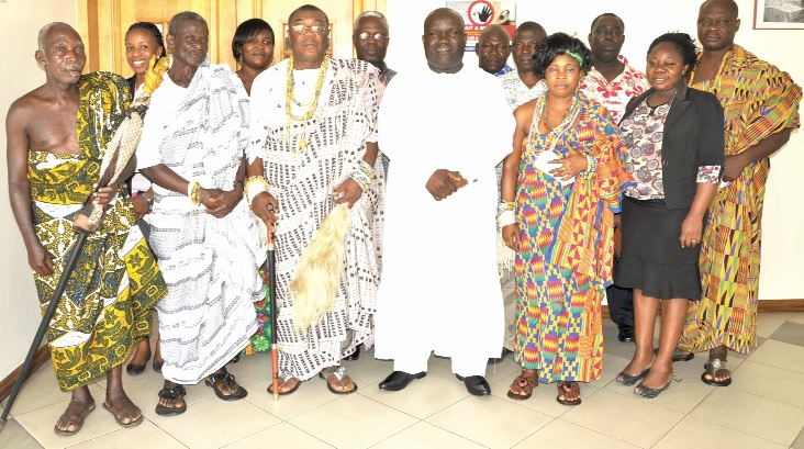 Mr Kenneth Ashigbey (4th left), in a group photograph with Togbe Koku Tsru II (3rd left), Awafiaga (Chief Warlord) of  the Ziavi Traditional Area, and his entourage and some staff of the Graphic Communications Group Limited. 