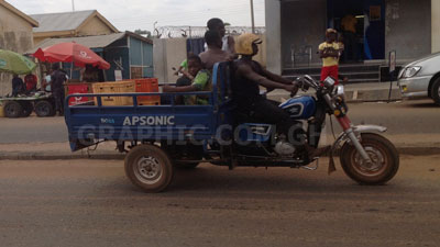 A rider transporting crates of soft drinks and children