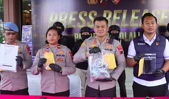 Investigators pose with evidence they collected during the murder inquiry
