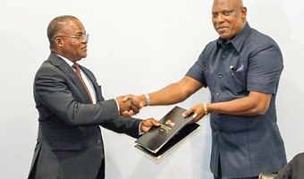 Ebenezer Ahumah Djietror (left), Clerk to Parliament, exchanging the signed MoU with Ato Afful, Managing Director, Graphic Communications Group Ltd. Picture: ELVIS NII NOI DOWUONA 