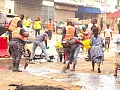 Personnel from Ghana Police Service, Zoomlion Ghana Limited, supported by community members, clearing silt and waste from sections of the road during the cleanup exercise at Accra Central