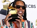 Lil Durk holding the Grammy Award he won for best melodic rap performance in 2024