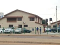 The pavement along the East Legon ARS Roundabout that has been encroached upon by the car dealership to display vehicles, forcing pedestrians to walk on gutter covers