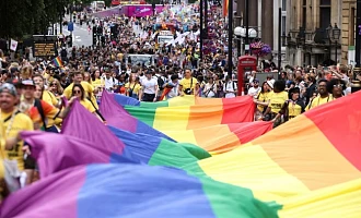 People carry a large rainbow flag, as they take part in the 2022 Pride Parade in London, Britain July 2, 2022. REUTERS/Henry Nicholls