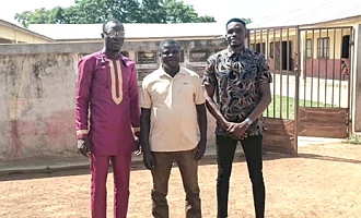 Samuel Donkor (middle) with the two newly posted teachers, Simon Uwumborlayi (left) and Jagri Thomas Ntesan (right), pose in front of the school