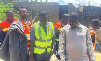 Emmanuel Kwesi Dawood Mensah (right), Central Regional NADMO Director, and other NADMO officials  visiting Ekon, an affected surburb in Cape Coast