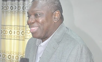Michael Harry Yamson (left), Administrator of the District Assemblies Common Fund, addressing the meeting