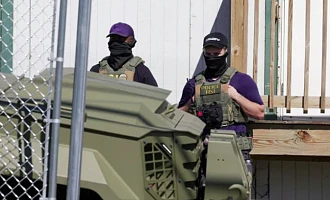 US Immigration and Customs Enforcement (ICE) agents stand guard in Newark, NJ, US [File: Jeenah Moon/Reuters]