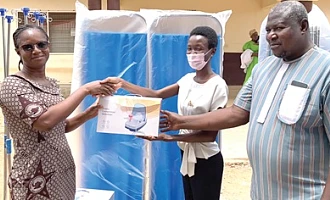 Dr Ama Antwiwaa Adu-Appiah (middle), Medical Officer at the Paga Hospital, presenting the items to Zita Abdulaih (left), Nurse Manager at the Paga Hospital. Looking on is Raphael Pariyewe (right), Organiser of the Paga Youth Movement