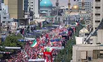 Crowds gathered on a boulevard in Mashhad leading to the gold-domed Imam Reza shrine