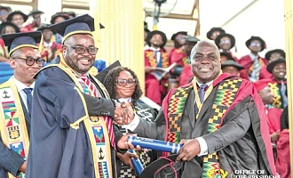 Dr Julius Debrah (right), the Chief of Staff, receiving his PhD during the graduation ceremony at the University of Ghana, Legon