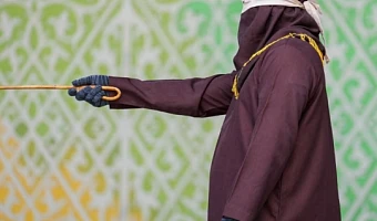 A robed and hooded official prepares to flog a Sharia law violator in Banda Aceh, Indonesia on Thursday. Photograph: Muhammad Iqbal/Zuma Press Wire/Shutterstock