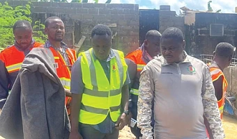 Emmanuel Kwesi Dawood Mensah (right), Central Regional NADMO Director, and other NADMO officials  visiting Ekon, an affected surburb in Cape Coast