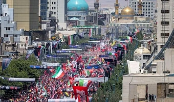 Crowds gathered on a boulevard in Mashhad leading to the gold-domed Imam Reza shrine