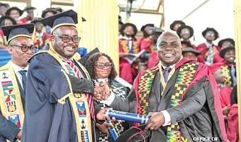 Dr Julius Debrah (right), the Chief of Staff, receiving his PhD during the graduation ceremony at the University of Ghana, Legon