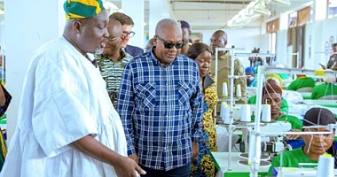 President John Dramani Mahama being conducted around the facility by Alhaji Nurideen Mohammed (left), CEO, Northshore Apparel Hub