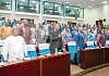 Members of the Togolese National Assembly on their feet for the playing of the country’s national anthem
