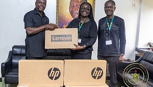 Dr Gideon Boako, spokesperson for the Vice- President (left) presenting one of the laptops to Prof Rita Akosua Dickson, Vice-Chancellor of the KNUST (second from right). With them is the Registrar of the school